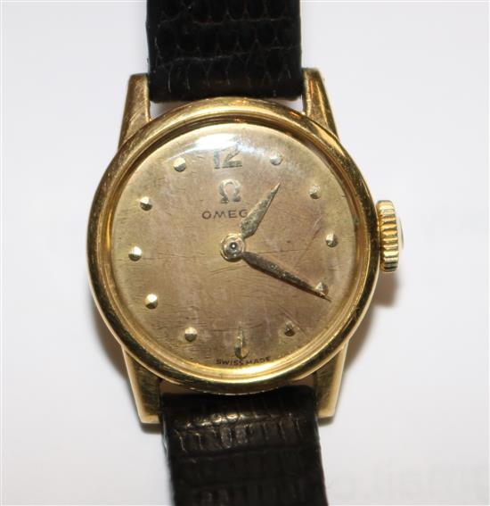 A ladys 1950s 18ct gold Omega manual wind wrist watch.
